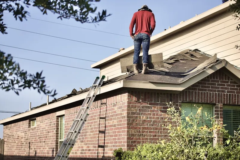 Professional roofer working on a residential roof in Windom